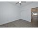 Light and airy bedroom with fan, closet, and door to the bathroom at 32017 N Redding St, Wittmann, AZ 85361