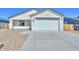 Charming single-story home with a well-maintained facade, two-car garage and desert landscaping at 32017 N Redding St, Wittmann, AZ 85361