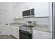Updated kitchen with stainless steel appliances, granite countertops and new white cabinets at 32017 N Redding St, Wittmann, AZ 85361