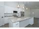 Modern kitchen with stainless steel appliances, stone countertops, a center island, and pendant lighting at 32017 N Redding St, Wittmann, AZ 85361