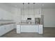 Bright kitchen with white cabinets, stainless steel appliances, and a large island with marble countertop at 32017 N Redding St, Wittmann, AZ 85361