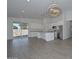 Modern kitchen featuring an island, stainless steel appliances, and a sliding glass door to the backyard at 32017 N Redding St, Wittmann, AZ 85361