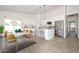 Bright, open kitchen and dining area features white cabinets, island with bar seating, and stainless steel appliances at 32017 N Redding St, Wittmann, AZ 85361