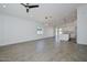 Open living space showcasing tile flooring, recessed lighting and connecting kitchen with stainless appliances at 32017 N Redding St, Wittmann, AZ 85361