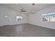 Spacious living room with tile floors and two windows letting in ample natural light at 32017 N Redding St, Wittmann, AZ 85361