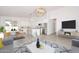 Spacious open-concept living area featuring a modern kitchen, dining space, and a comfortable living room at 32017 N Redding St, Wittmann, AZ 85361