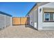 Side yard featuring secure wooden gate access, providing privacy and functionality to the property at 32017 N Redding St, Wittmann, AZ 85361
