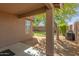 The covered back patio offers serene views of the lush yard, perfect for outdoor living at 3313 W Five Mile Peak Dr, San Tan Valley, AZ 85144
