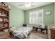 Comfortable bedroom featuring light green walls, light wood floors, and a sunny window with shutters at 3313 W Five Mile Peak Dr, San Tan Valley, AZ 85144