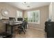 Bright home office with plantation shutters, tile flooring, and a functional desk setup at 3313 W Five Mile Peak Dr, San Tan Valley, AZ 85144
