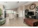 Spacious living area with open layout, tile flooring, and a large decorative clock on the wall at 3313 W Five Mile Peak Dr, San Tan Valley, AZ 85144