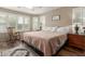 Cozy main bedroom featuring hardwood floors, shutters, a rocking chair, and a warm color palette at 3313 W Five Mile Peak Dr, San Tan Valley, AZ 85144