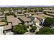 Wide aerial view of a neighborhood with uniform tile roofs, highlighting community layout and landscape at 3330 E Carla Vista Dr, Gilbert, AZ 85295