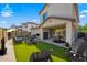 Outdoor patio featuring synthetic grass, outdoor seating, and a grill with desert landscaping at 3330 E Carla Vista Dr, Gilbert, AZ 85295