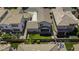 Aerial view of backyard features low-maintenance turf, lounge area, and verdant landscaping at 3330 E Carla Vista Dr, Gilbert, AZ 85295