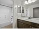 Clean bathroom featuring a shower-tub combo, modern fixtures, and a vanity with a large mirror at 3330 E Carla Vista Dr, Gilbert, AZ 85295