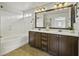 Bathroom featuring double sinks, granite countertop, and tile flooring, with a separate tub at 3330 E Carla Vista Dr, Gilbert, AZ 85295