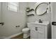 Stylish half bathroom with modern vanity, oval mirror, and sleek fixtures, enhancing the home's appeal at 3330 E Carla Vista Dr, Gilbert, AZ 85295