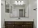 Bathroom featuring a vanity with dark wood cabinets, white countertops, and a large mirror at 3330 E Carla Vista Dr, Gilbert, AZ 85295