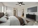 Comfortable bedroom featuring plush carpet, a ceiling fan, a TV, and neutral walls at 3330 E Carla Vista Dr, Gilbert, AZ 85295