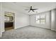 Spacious bedroom with neutral walls, carpeted floors, a ceiling fan, and natural light at 3330 E Carla Vista Dr, Gilbert, AZ 85295