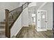 Elegant foyer featuring hardwood floors, a staircase with wrought iron railing, and neutral decor at 3330 E Carla Vista Dr, Gilbert, AZ 85295
