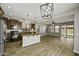 Open-concept kitchen and living room area features granite counters, stainless appliances, and wood look tile floors at 3330 E Carla Vista Dr, Gilbert, AZ 85295