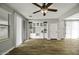 Open concept living room features wood look tile flooring, neutral paint, and sliding glass doors at 3330 E Carla Vista Dr, Gilbert, AZ 85295