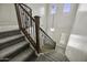 Staircase with carpeted steps, decorative iron railing, and a view to the foyer below at 3330 E Carla Vista Dr, Gilbert, AZ 85295