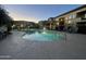 Relaxing community pool at dusk with lounge chairs and well-maintained landscaping at 3330 S Gilbert Rd # 2021, Chandler, AZ 85286