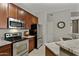 Modern kitchen with stainless steel appliances, granite countertops, and tile backsplash at 3330 S Gilbert Rd # 2021, Chandler, AZ 85286