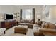 Comfortable living room with plush seating, media center, neutral carpet, and large window at 3330 S Gilbert Rd # 2021, Chandler, AZ 85286