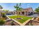 Gorgeous backyard featuring a pool, covered patio, landscaping, and artificial grass at 4089 E Peach Tree Dr, Chandler, AZ 85249