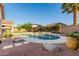 Inviting backyard pool with rock accents, mature landscaping, and an extended covered patio, perfect for entertaining at 4089 E Peach Tree Dr, Chandler, AZ 85249