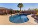 Backyard swimming pool with rock waterfall feature, lush landscaping, and a spacious patio area at 4089 E Peach Tree Dr, Chandler, AZ 85249