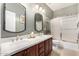 Dual-sink bathroom boasting marble countertops, updated cabinetry, and a shower-tub combination at 4089 E Peach Tree Dr, Chandler, AZ 85249