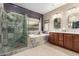 Beautiful bathroom featuring double sinks, decorative tile and backsplash, soaking tub, and updated shower at 4089 E Peach Tree Dr, Chandler, AZ 85249