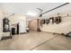 Well-lit two-car garage featuring built-in storage cabinets, a utility sink, and a water softener system at 4089 E Peach Tree Dr, Chandler, AZ 85249