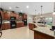 Well-equipped kitchen with dark cabinets, stainless steel appliances, and a large granite island at 4089 E Peach Tree Dr, Chandler, AZ 85249