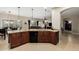 Open kitchen featuring wood cabinets, granite counters, and a breakfast bar overlooking the living area at 4089 E Peach Tree Dr, Chandler, AZ 85249