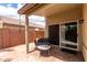 Back patio featuring a small seating area and sliding glass door at 4109 E Chambers St, Phoenix, AZ 85040