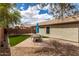 Backyard area featuring artificial turf, gravel landscaping, and an outdoor dining space at 4109 E Chambers St, Phoenix, AZ 85040