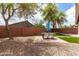 Landscaped backyard features gravel, artificial turf, and patio with an outdoor table at 4109 E Chambers St, Phoenix, AZ 85040