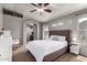 Comfortable bedroom features a ceiling fan and well lit bedside table with views of the neighborhood at 4109 E Chambers St, Phoenix, AZ 85040