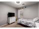 Well-lit bedroom features a single bed, dresser, and a window view at 4109 E Chambers St, Phoenix, AZ 85040