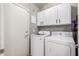 Laundry area with white cabinets, washer, and dryer at 4109 E Chambers St, Phoenix, AZ 85040