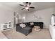 Comfortable living room with dark grey sectional sofa, and light grey walls at 4109 E Chambers St, Phoenix, AZ 85040