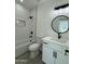 Bright bathroom with a shower/tub combo and a modern vanity with black fixtures at 4116 E Park St, Phoenix, AZ 85042
