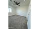Neutral bedroom with ceiling fan, carpet flooring, and natural light from the window at 4116 E Park St, Phoenix, AZ 85042