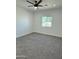 Bright bedroom featuring neutral carpet, recessed lighting, and a window at 4116 E Park St, Phoenix, AZ 85042